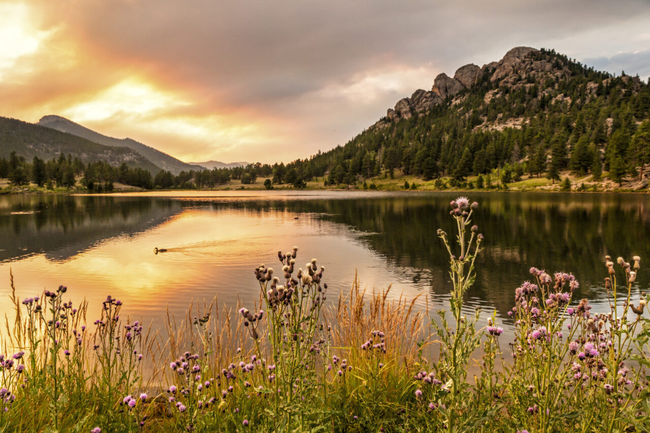 Smoky clouds just after the sun sets over Lily Lake in Rocky Mountain National Park, Estes Park, Colorado.
